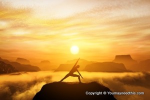 Woman standing in yoga position, meditating in mountains